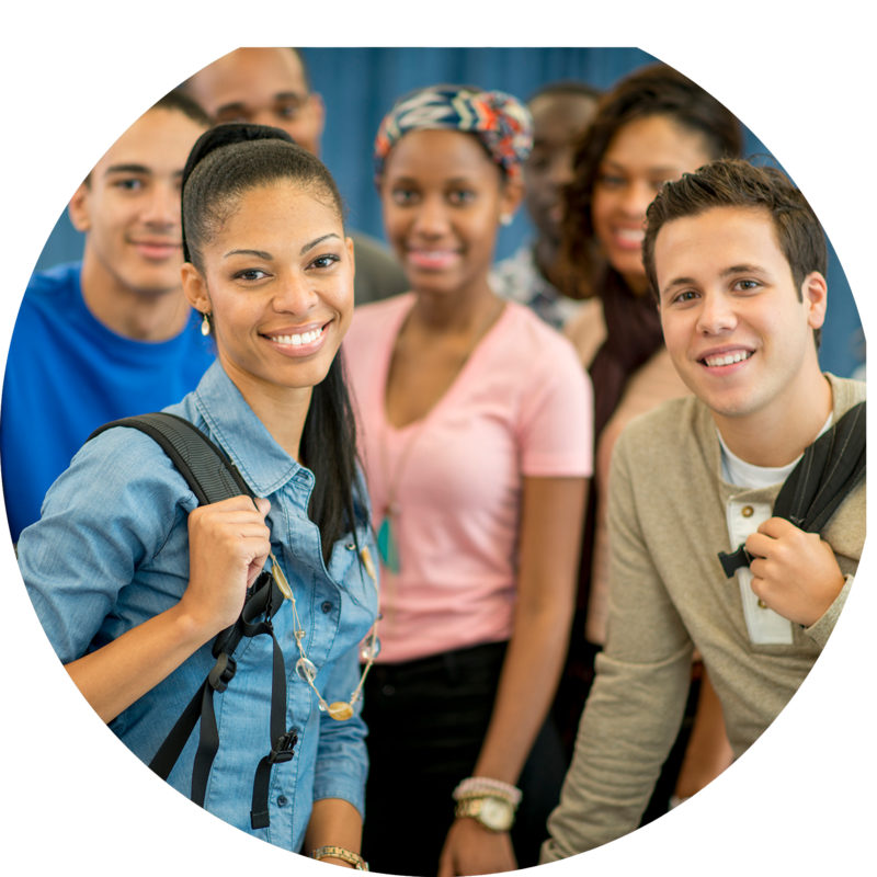 Group of young adults both male and female smiling in school or college setting