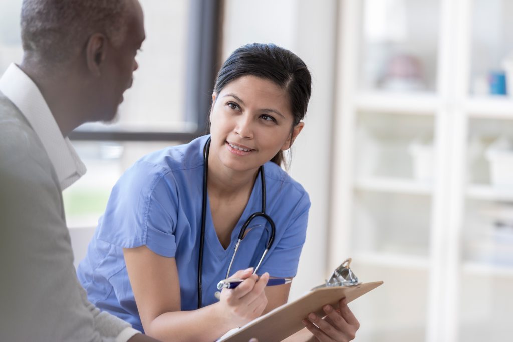 Photo of a certified nursing assistant interacting with a client