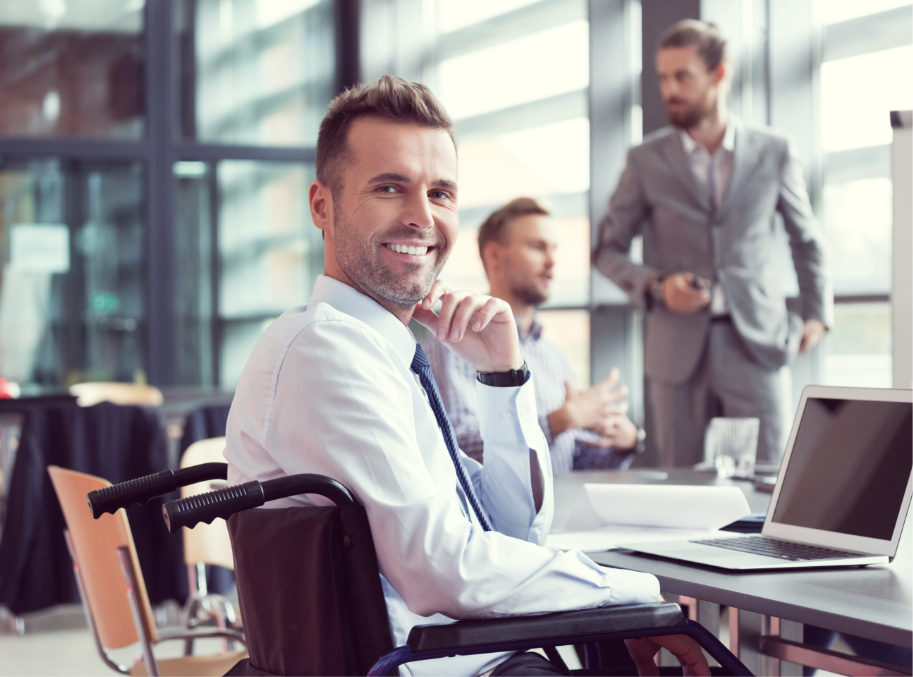 Professionally dressed man in wheelchair working in conference room